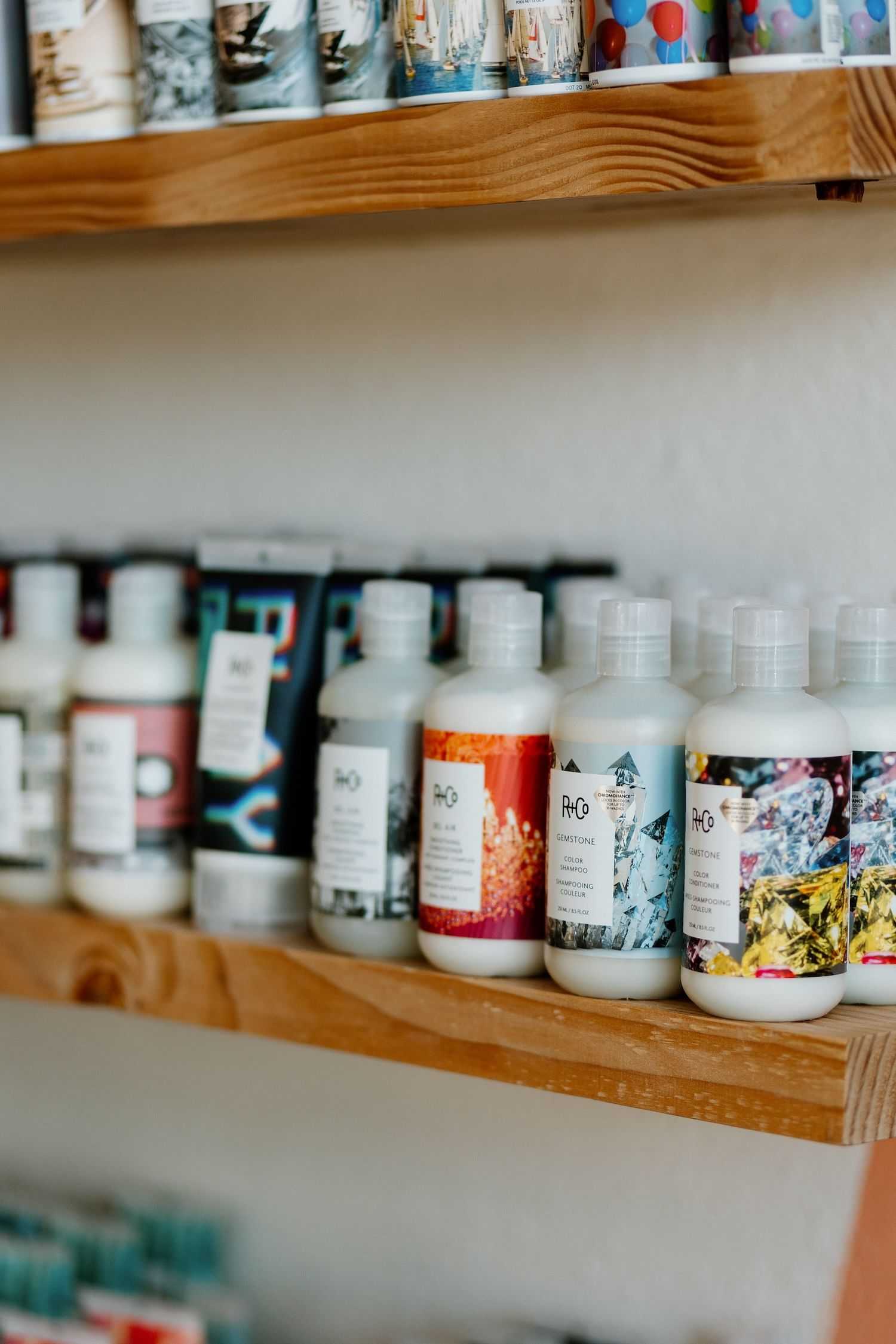 Variety of hair care products displayed on a salon shelf.
